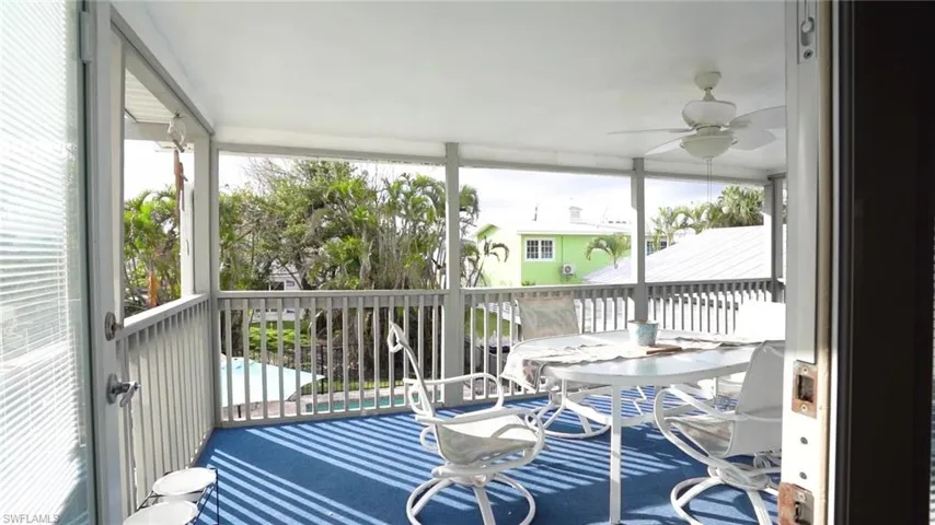 featuring ceiling fan over looking the pool and pool cottage