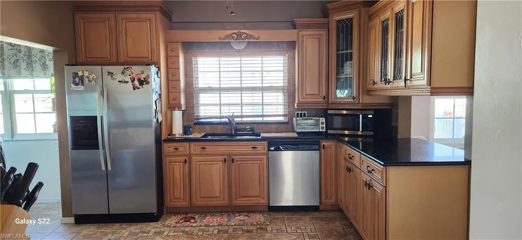 Kitchen with sink, stainless steel appliances, and a healthy amount of sunlight