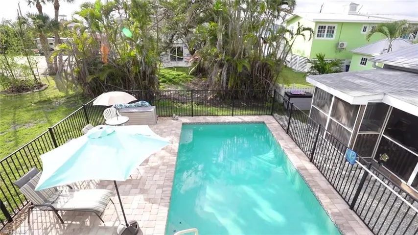 View of pool with a yard and a sunroom