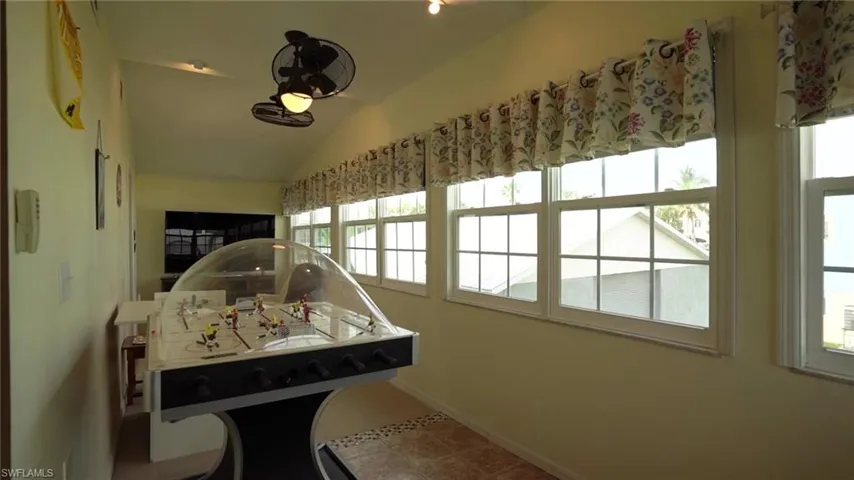 Game room with vaulted ceiling