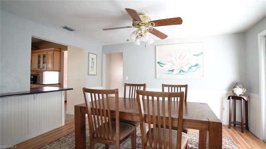 Dining room with light hardwood / wood-style floors and ceiling fan