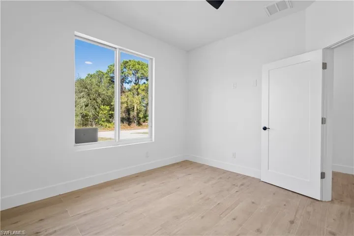 Unfurnished room with light hardwood / wood-style flooring