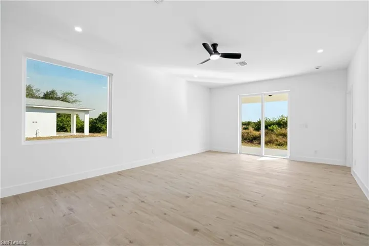 Spare room featuring ceiling fan and light hardwood / wood-style floors