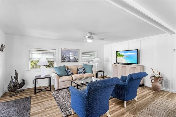 Living area featuring light wood finished floors and a ceiling fan