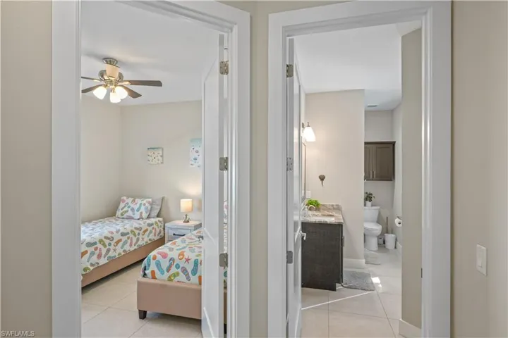 Bedroom featuring light tile patterned floors and ceiling fan