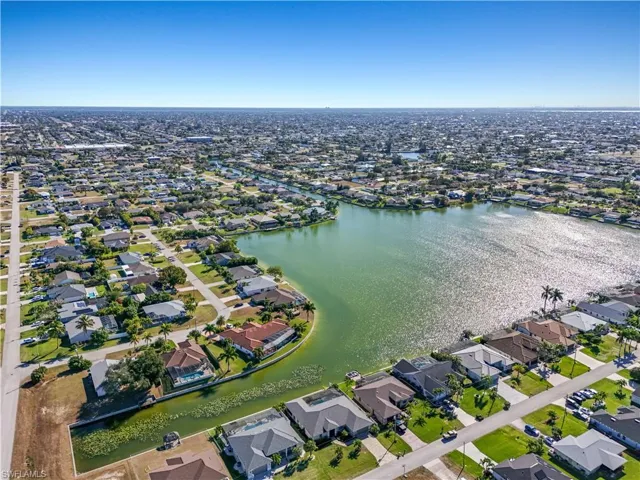 View of property location with nearby suburban area and a nearby body of water