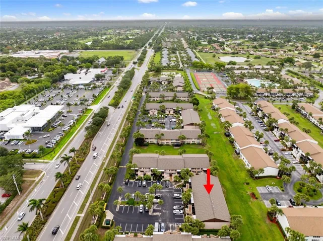 Aerial view of residential area with a major roadway and a nearby body of water