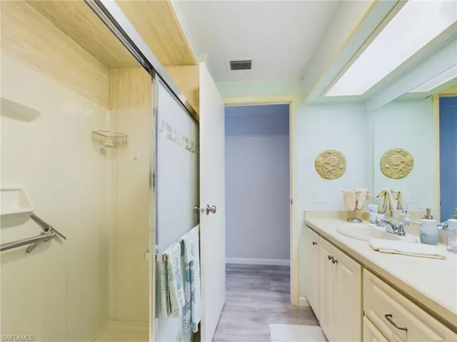 Bathroom featuring hardwood / wood-style flooring and vanity