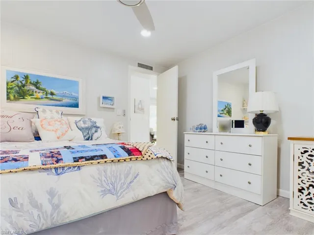 Bedroom with ceiling fan and light wood-type flooring