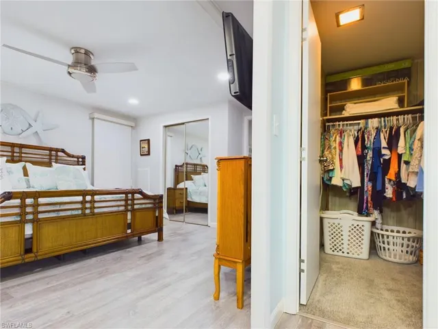 Bedroom featuring light wood-type flooring, a closet, and ceiling fan