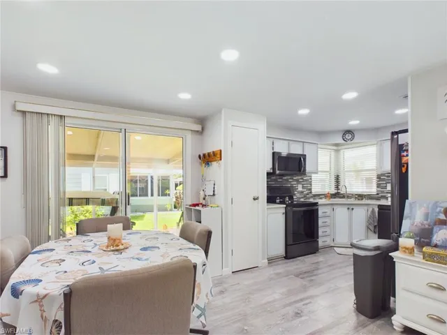Dining area featuring light wood-type flooring, sink, and a wealth of natural light