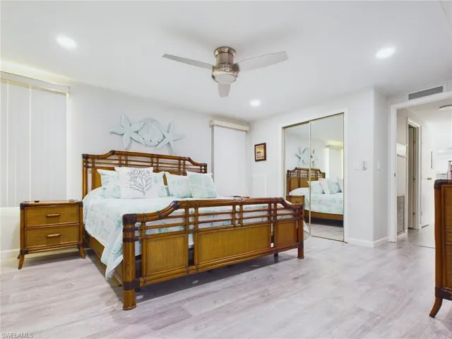 Bedroom featuring ceiling fan, wood-type flooring, and a closet