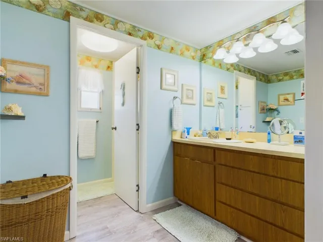 Bathroom with vanity and wood-type flooring