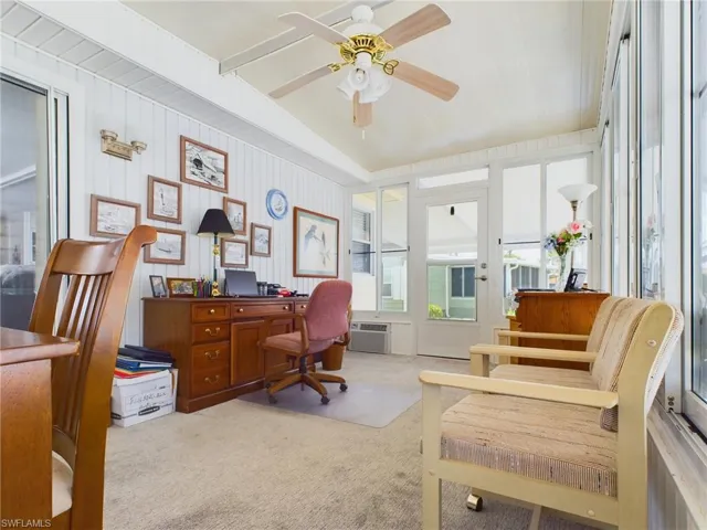 Carpeted home office with ceiling fan and a wall mounted AC
