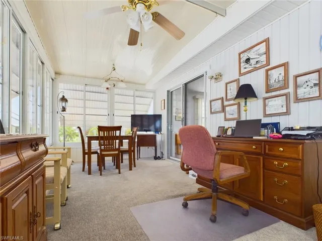 Carpeted office space with ceiling fan