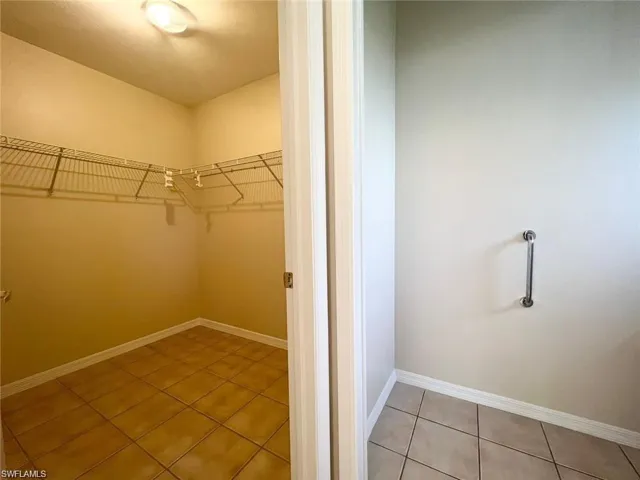 Spacious closet with tile patterned floors