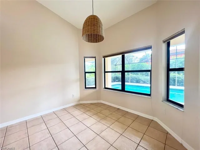 Tiled spare room with a wealth of natural light