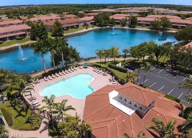 Birds eye view of property with a water view