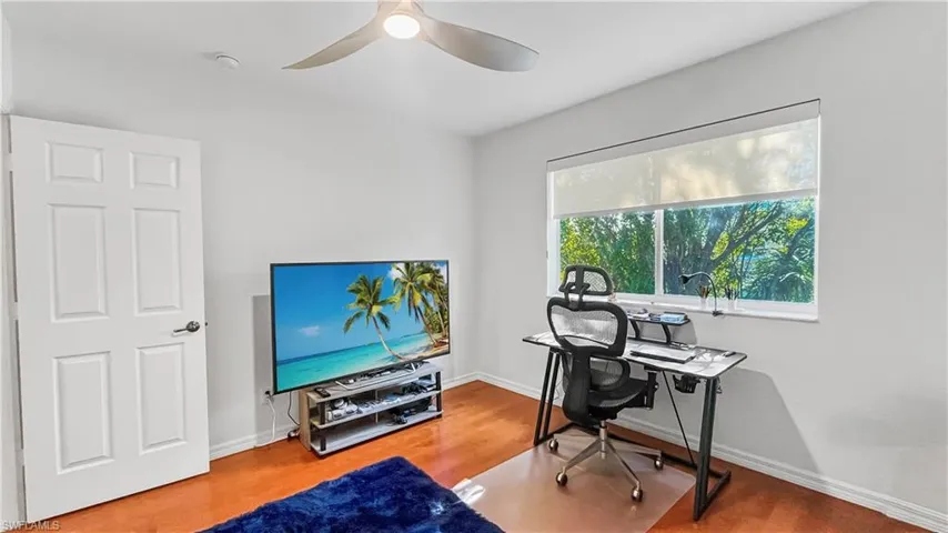 Office with ceiling fan and hardwood / wood-style flooring