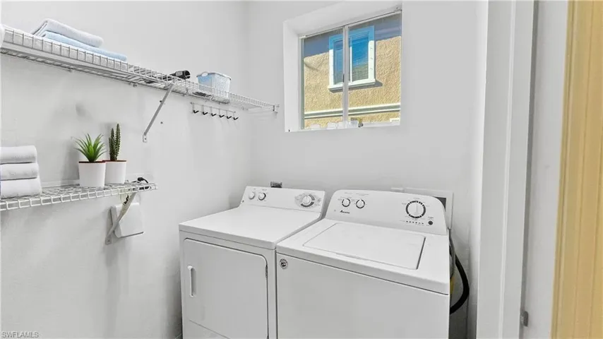 Clothes washing area featuring separate washer and dryer