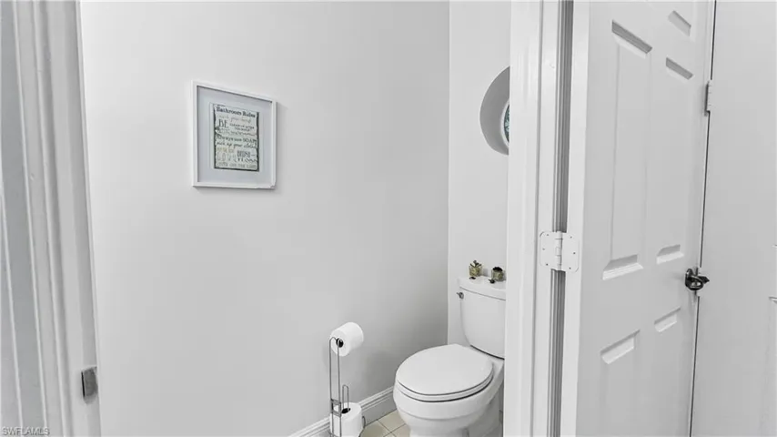 Bathroom featuring toilet and tile patterned flooring