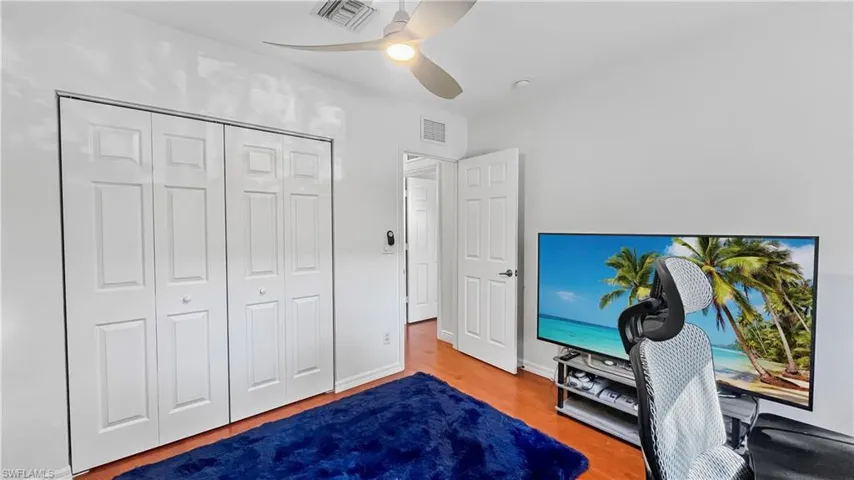 Bedroom featuring ceiling fan, a closet, and wood-type flooring