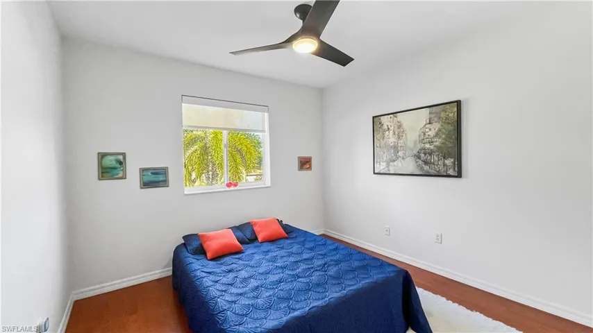 Bedroom with ceiling fan and wood-type flooring