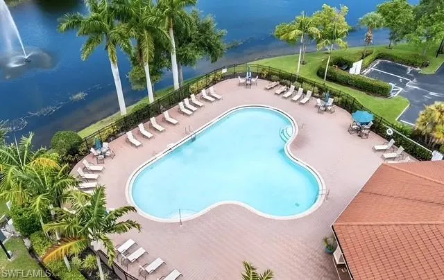 View of pool with a patio area and a water view