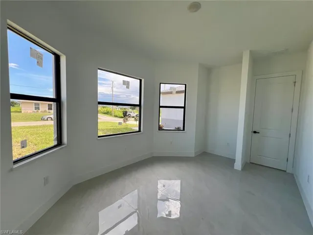 Unfurnished bedroom featuring light tile patterned flooring and multiple windows