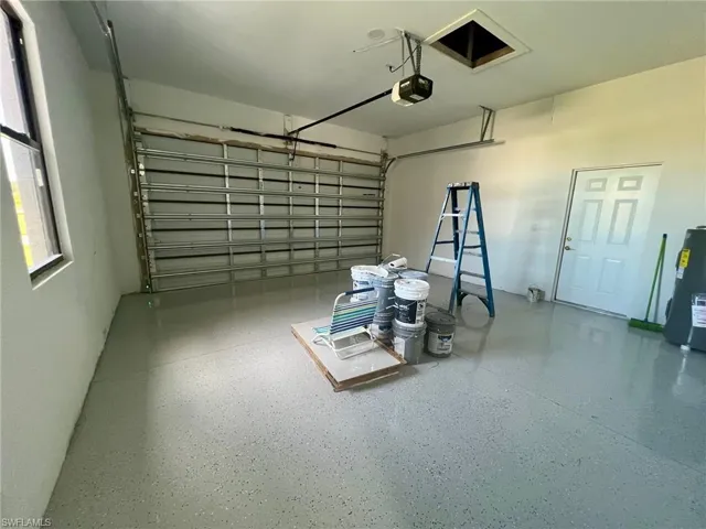 Garage with water heater and a garage door opener