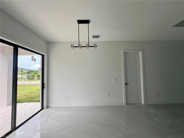 Tiled empty room featuring plenty of natural light
