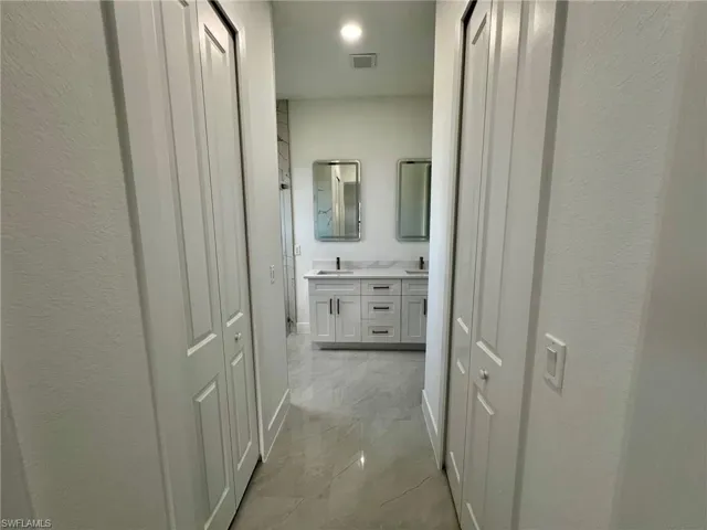 Corridor featuring light tile patterned flooring