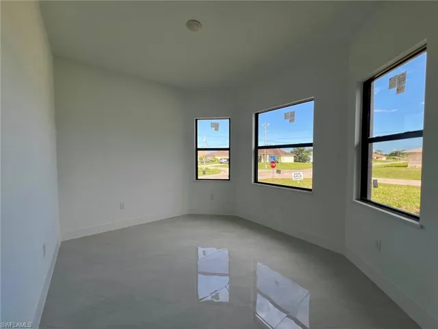 Unfurnished room featuring tile patterned floors and a wealth of natural light