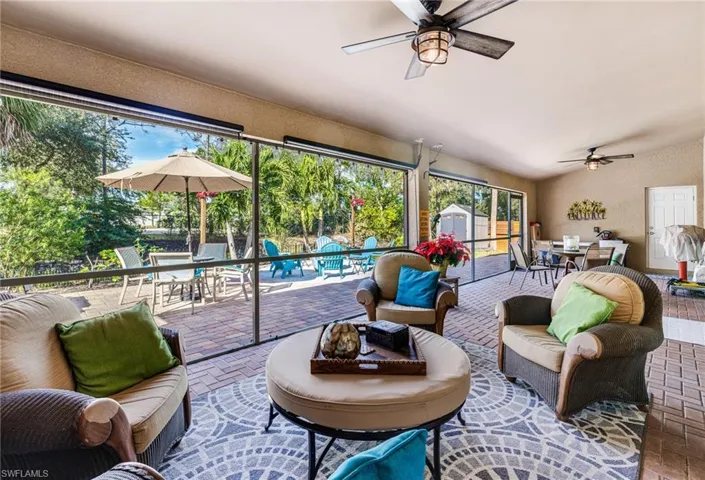 Sunroom with ceiling fan, plenty of natural light, and vaulted ceiling