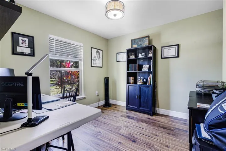 Office with light hardwood / wood-style flooring