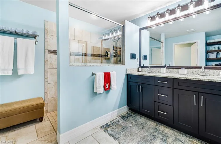 Bathroom with vanity and a tile shower