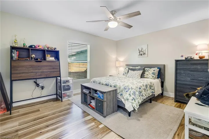 Bedroom featuring ceiling fan and wood-type flooring