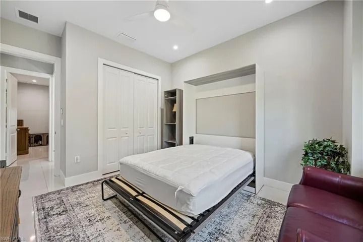 Bedroom with recessed lighting, a ceiling fan, a closet, and light tile patterned flooring