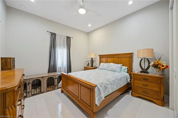 Bedroom featuring light tile patterned floors, a ceiling fan, and recessed lighting