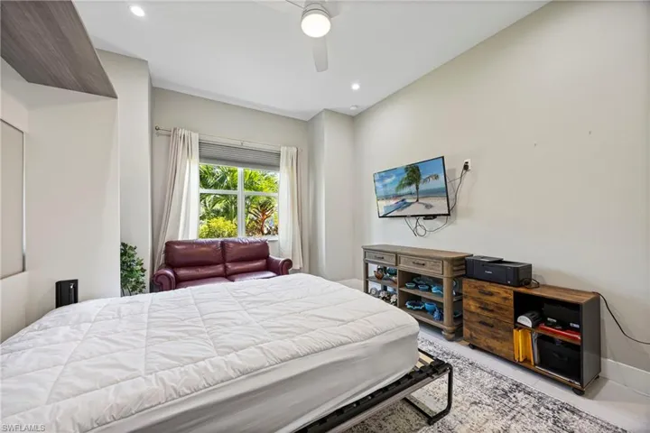 Bedroom with a ceiling fan and recessed lighting