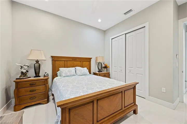 Bedroom featuring a closet, a ceiling fan, light tile patterned flooring, and recessed lighting