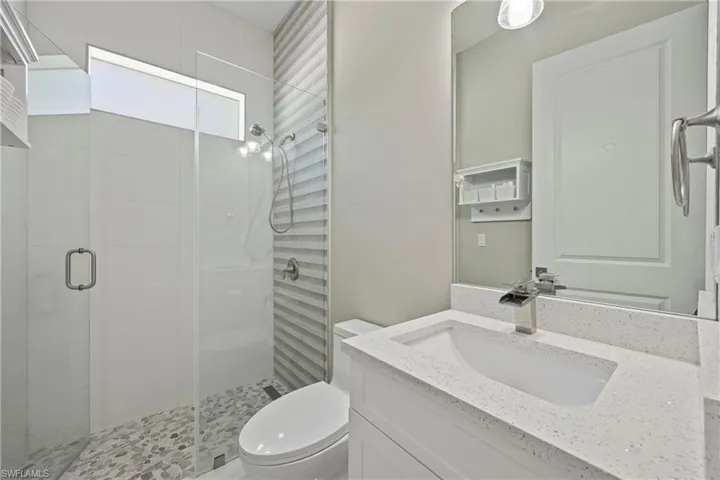 Bathroom featuring a stall shower and vanity