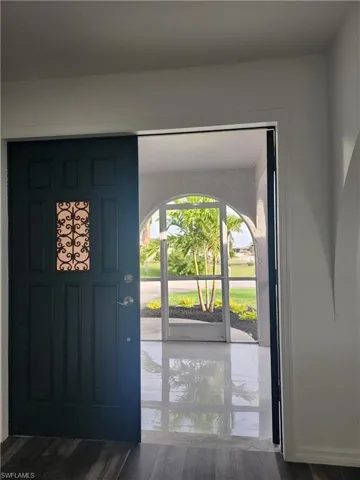 Double Door Entry thru Tiled and newly screened porch.  Great for those cool Florida mornings.