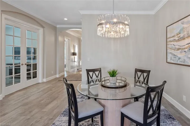 This expansive extended lanai offers a seamless indoor-outdoor lifestyle with a mounted TV, beautiful paver flooring, and a tranquil poolside setting. Designed for both entertaining and relaxing, it’s the ideal spot to unwind while enjoying the peaceful water views.