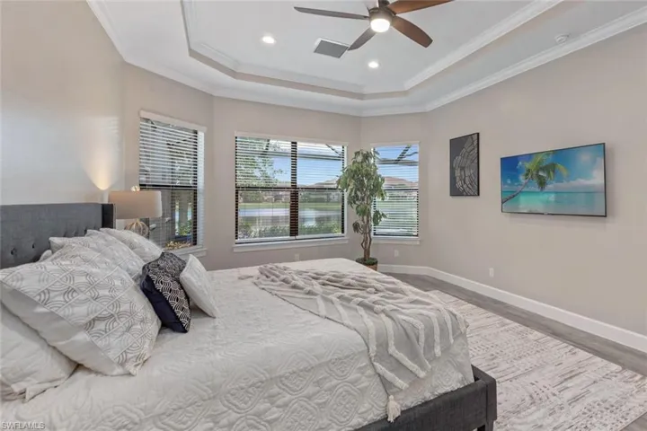 Enjoy the perfect blend of relaxation and scenery from this sparkling pool, where the waterfall spa cascades into the water and the panoramic screen cage frames uninterrupted lake views for a true resort-like experience.