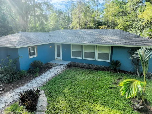 Ranch-style house with a front yard and a patio