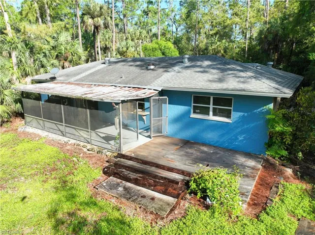 Back of house with a sunroom