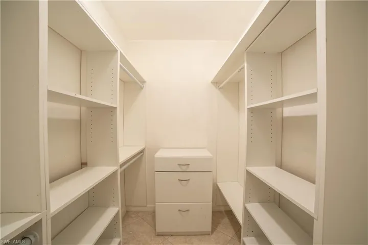 Spacious closet featuring light tile patterned floors