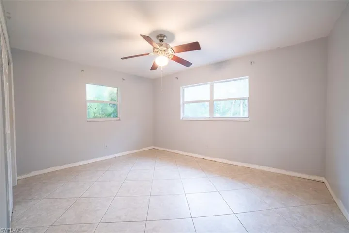 Spare room with light tile patterned floors and ceiling fan