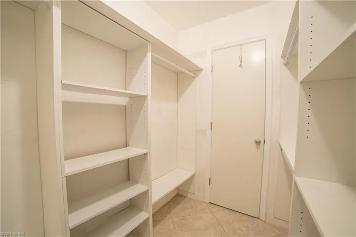 Spacious closet with light tile patterned flooring